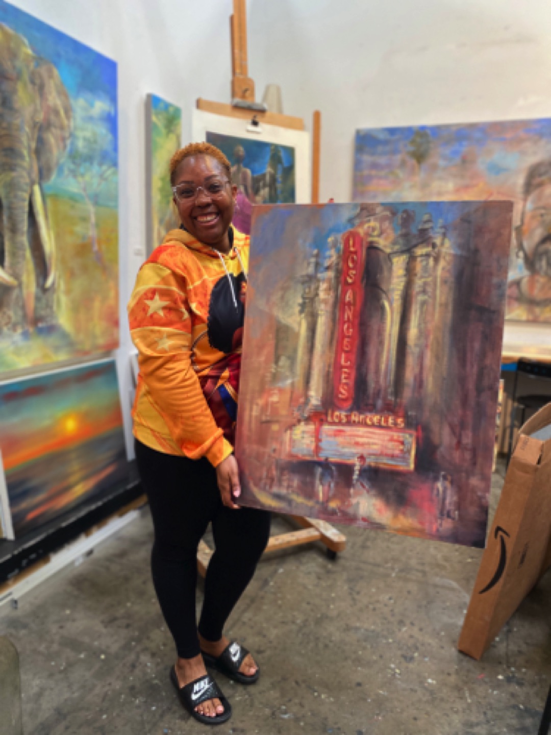 Collector Tiffany Montgomery with her new addition to her growing collection of Gregg Chadwick paintings.